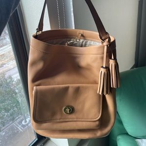 Coach bucket bag with tassel. Comes with dust bag.